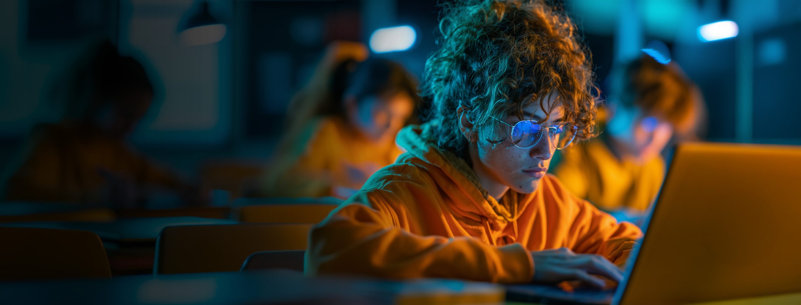 Student focused on a laptop in a classroom
